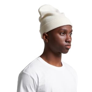 Natural as colour cuff beanie worn by male model looking into the distance thinking about life