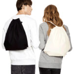 man and woman models wearing black and natural draw string bags
