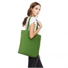 green earth positive tote carried by female model