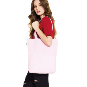Earth Positive Tote Bag in pink carried by female model